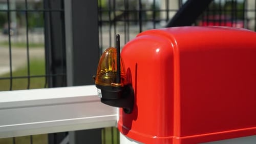 Electrician connects the yellow Signal Lamp for the gate. Warning yellow flash lamp