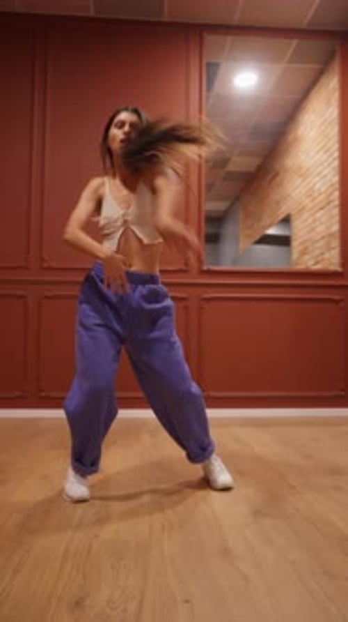 Woman Dancing in Crop Top and Blue Pants