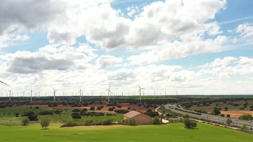 Wind Turbines in Vast Rural Landscape with Highway