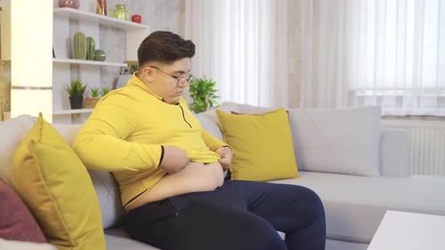 Young Adult Man Concerned About Stomach Size