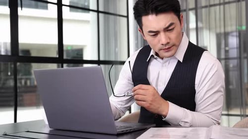 Professional Man Working at Laptop in Modern Office