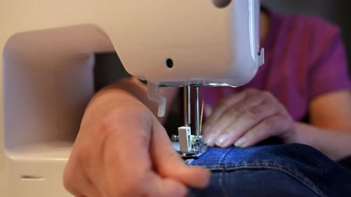 Woman Sewing Denim on Sewing Machine in Home