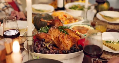 Food, thanksgiving and hands with turkey, wine and table setting for reunion