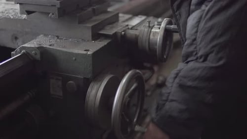 Man Operating Metal Lathe