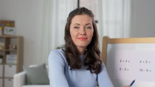 Woman Teaching Math with Whiteboard in Home Setting