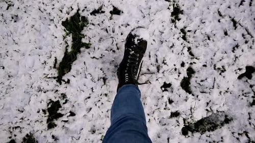 Person Walking Through Snow Covered Ground