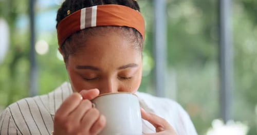 Woman Smiling While Drinking Coffee Indoors
