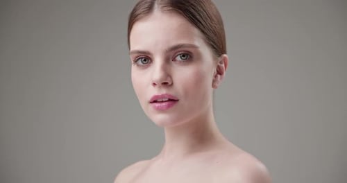 Woman Posing in Front of Gray Background