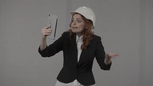 Woman Construction Worker Video Calling Using Tablet