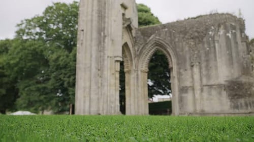Glastonbury Abbey ruins central part, camera pan bottom to top 4k slow motion.