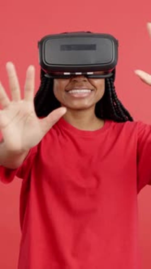 Young Woman Using VR Headset on Red Background
