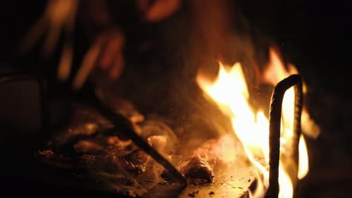 Roasting meat, ham on open fire, epic flames