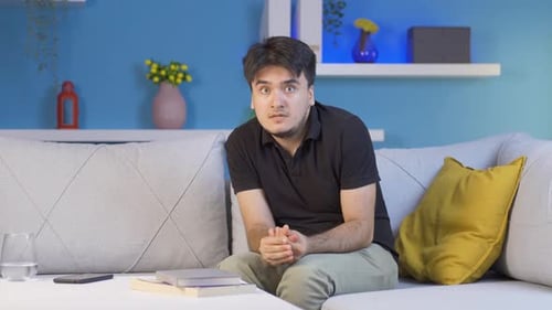 Man looking at camera with coward expression.