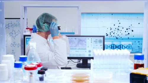 Scientist Examines Petri Dish in Bright Laboratory