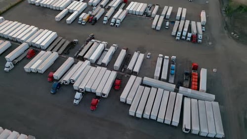 Trailer Semi Truck Driver Exiting Truck Stop Parking Lot Aerial Drone Move Wide Footage