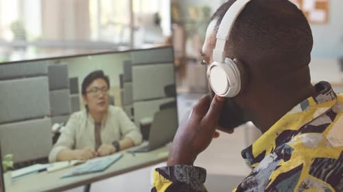 Man Attends Online Video Meeting in Modern Office
