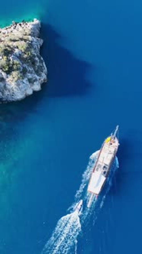Drone footage vertical of gulet at open sea