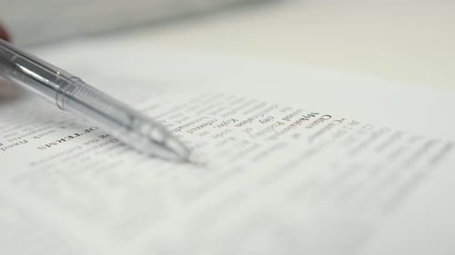 Close-up: woman lawyer office worker proofreading a contract before signing
