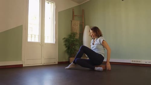 Woman Doing Seated Twist Stretch Exercise at Home