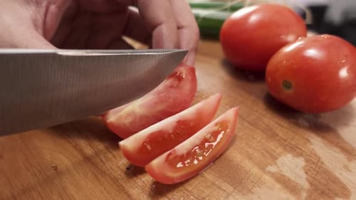 Tomato Slicing on Wood Cutting Board in Kitchen