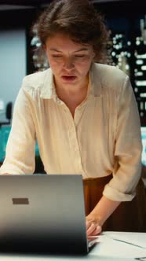 Vertical Video Enterprise Worker Engaged in Researching Market Data for a New Strategy