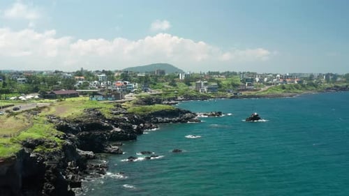 A view of the blue and clear coast of Jeju Island and the horizon.