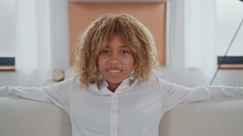 Smiling Woman Relaxing on Sofa