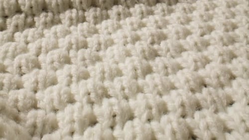 Knitted white fabric texture close up