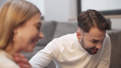 Smiling Man Talking and Laughing Indoors at Home