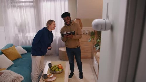 Couple Set Up Security Camera at Home