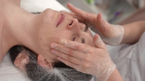 The Cosmetologist Makes Massage to the Client Face Makes Procedures in the Spa or Salon Closeup Skin
