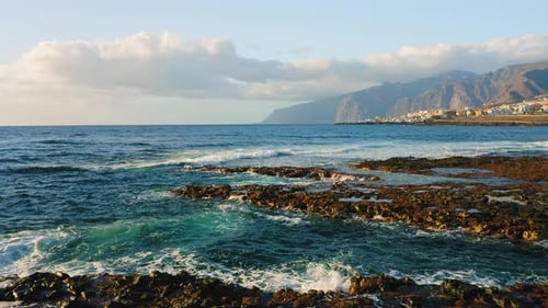 Empty Rocky Volcanic Beach of Atlantic Ocean in the Soft Morning Light Flying Low Over the Breaking
