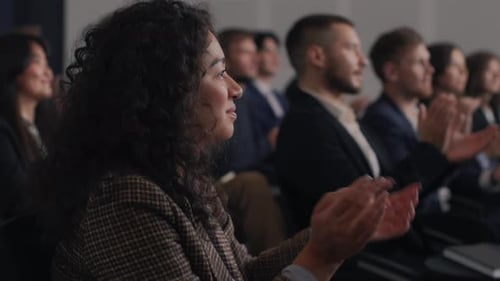 Audience Applauding Presentation at Corporate Business Conference