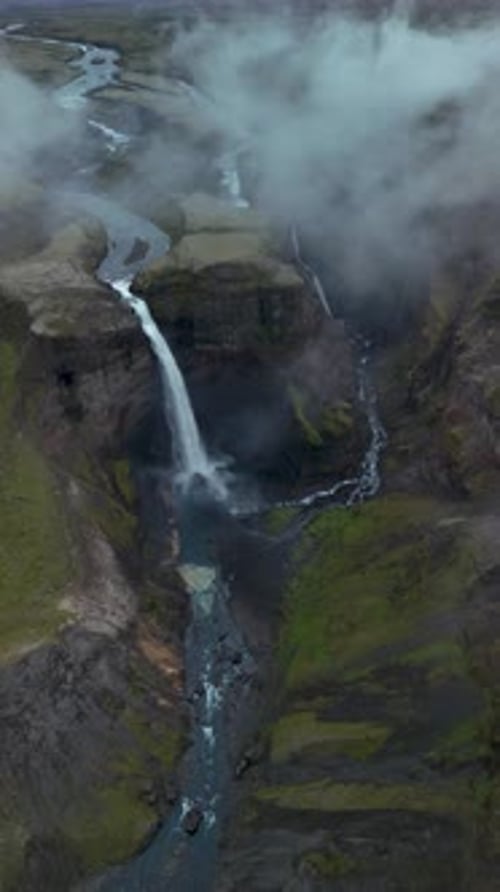 Majestic Waterfall Cascading into a Verdant Canyon
