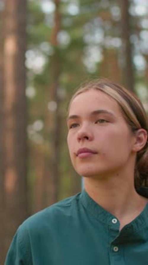Young Woman Hiking Through Serene Forest Trail with Friend