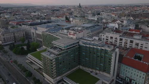 Backwards Fly Above Modern Hotel Complex Near Historic Town Center Revealing Waterfront Road and