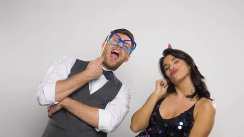 Couple Posing With Party Props in Studio