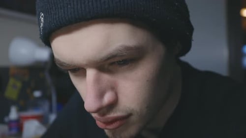 Serious Face Of A Caucasian Man While Reading On Something. - Close Up Shot