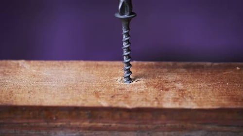 Drill Driving Screw Into Piece of Wood