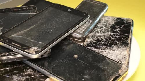 Pile of Broken and Damaged Mobile Phones