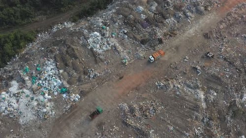 Aerial View of Landfill with Trucks Disposing Waste