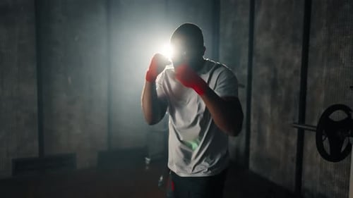 Man Boxing Training Punches in Gym African American Sportive Focused Boxer Fighter Practicing Hits
