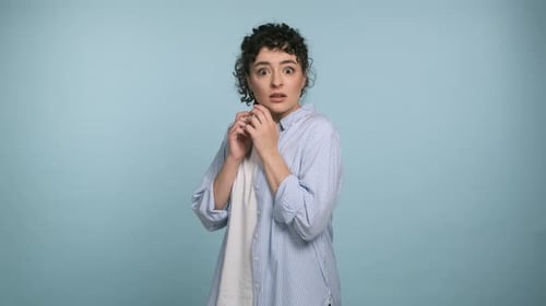Woman Looking Scared and Shocked in Studio