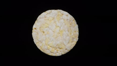 Round crispy dry corn tortilla. Rotates on a black background, top view.