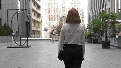 A businesswoman with a confident gait goes to work to reach new heights.