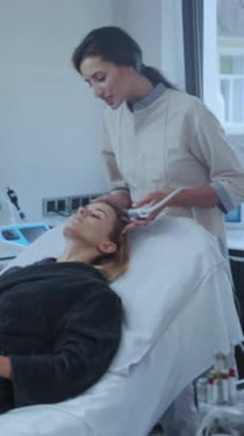 Woman Receiving Facial Treatment in Medical Clinic