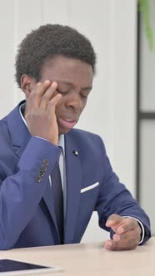 Young Businessman Having a Headache in Office