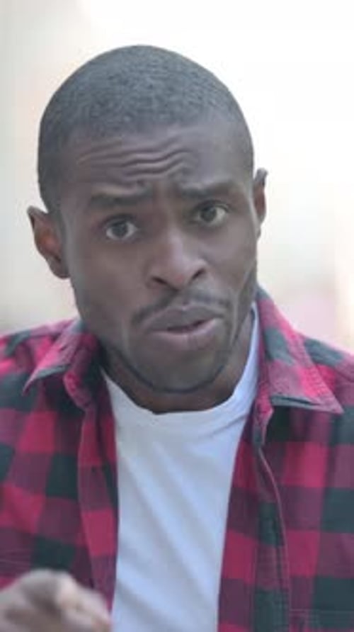 Outdoor Portrait of Upset Young African Man Doing Video Chat, Vertical Video