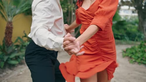 Happy latin american street dancers performing choreography in city park slow motion