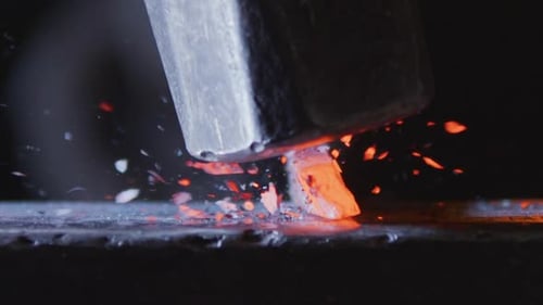 Hammer Strikes Hot Metal on Anvil in Close Up